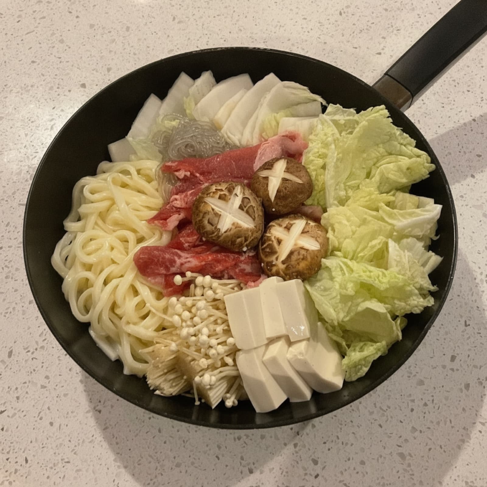 Vanessa's hotpot spread: beef, cabbage, shiitake, udon and tofu ready to cook.